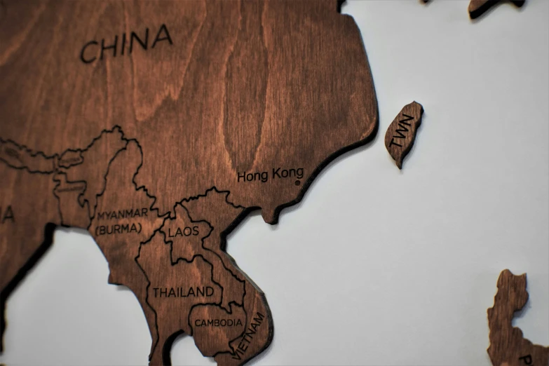 a close up of a map of the world, a jigsaw puzzle, by Daniel Lieske, trending on unsplash, conceptual art, vietnam, carved in wood, 3/4 side view, in hong kong