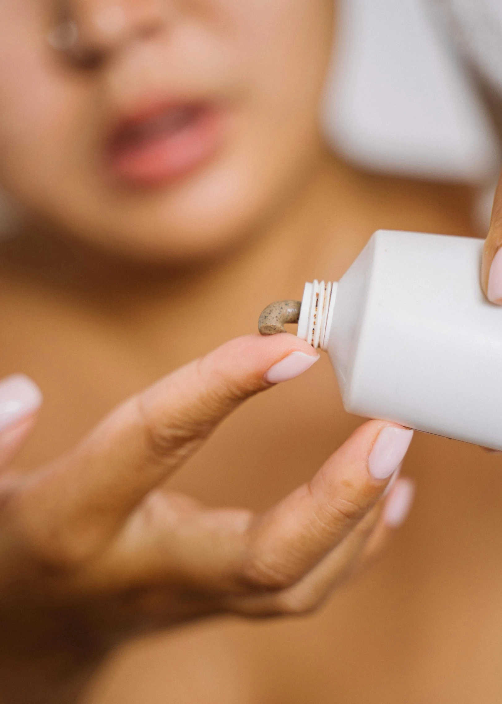 a woman holding a tube of toothpaste in one hand and a tube of toothpaste in the other, trending on pexels, happening, oiled skin, hibernation capsule close-up, brown, filling the frame