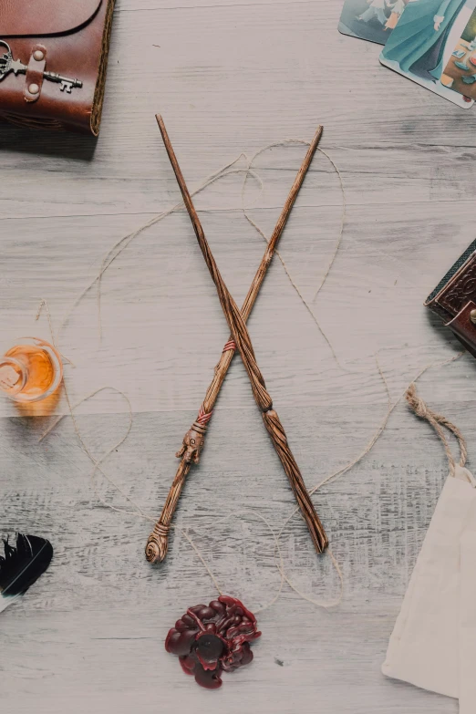 a table that has a bunch of items on it, inspired by Hermione Hammond, trending on pexels, renaissance, magic wooden staff, promo image, scorpion whip, hogwarts legacy