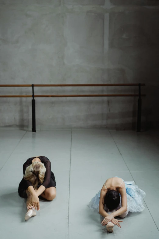 a couple of people sitting on top of a floor, by Caro Niederer, unsplash, conceptual art, ballet, looking exhausted, square, panorama