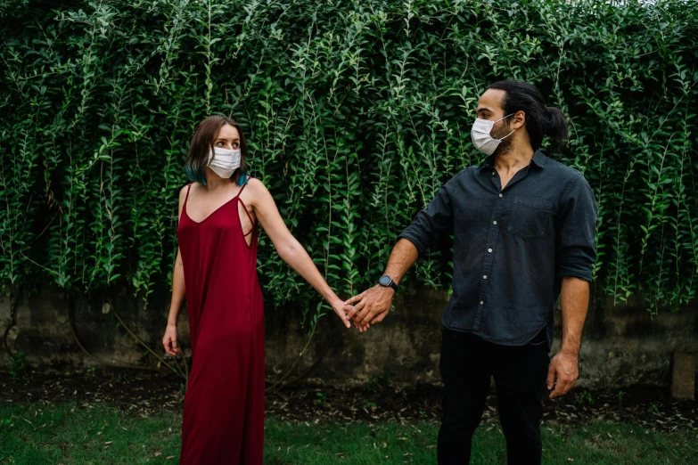 a man and woman holding hands in front of a hedge, pexels contest winner, renaissance, surgical mask covering mouth, jordan grimmer and natasha tan, thumbnail, caucasian