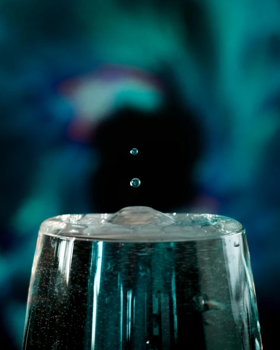 a glass filled with water sitting on top of a table, an album cover, unsplash, holography, fine bubbles, thirst, backscatter orbs, closeup shot