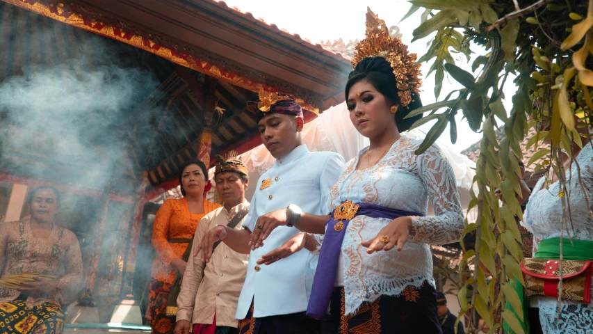 a group of people standing next to each other, ceremonial ritual, pregnant, ornate and intricate jewelry, arsitektur nusantara