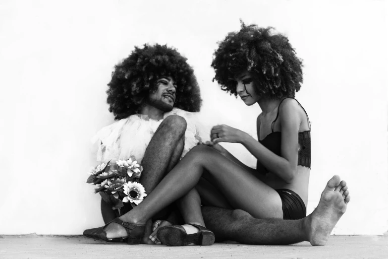 a man and a woman sitting next to each other, a black and white photo, by Maurycy Gottlieb, funk art, long afro hair, flower power, brazil, wig