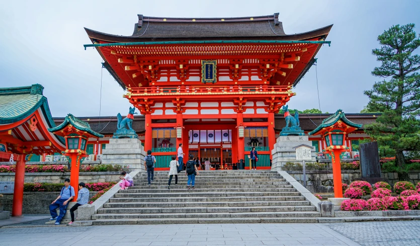 a group of people that are standing in front of a building, inspired by Torii Kiyomasu, pexels contest winner, square, shrines, colorful building, 🚿🗝📝