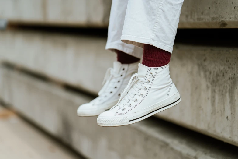 a pair of white sneakers sitting on a ledge, pexels contest winner, close-up on legs, stacked, white head, dressed casually