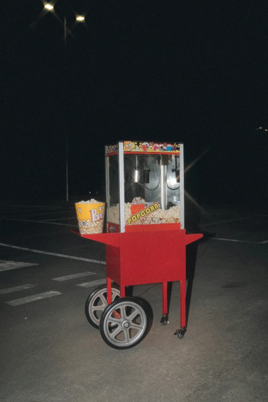 a popcorn cart in a parking lot at night, an album cover, by Elsa Bleda, mr beast, ( ( photograph ) ), single image