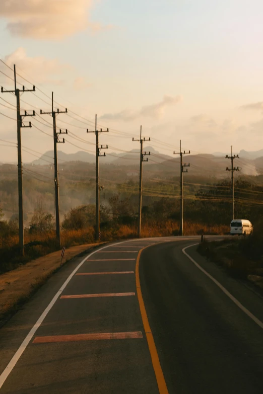 a car that is sitting on the side of a road, inspired by Elsa Bleda, pexels contest winner, power lines, sri lankan landscape, mexico, low quality photo