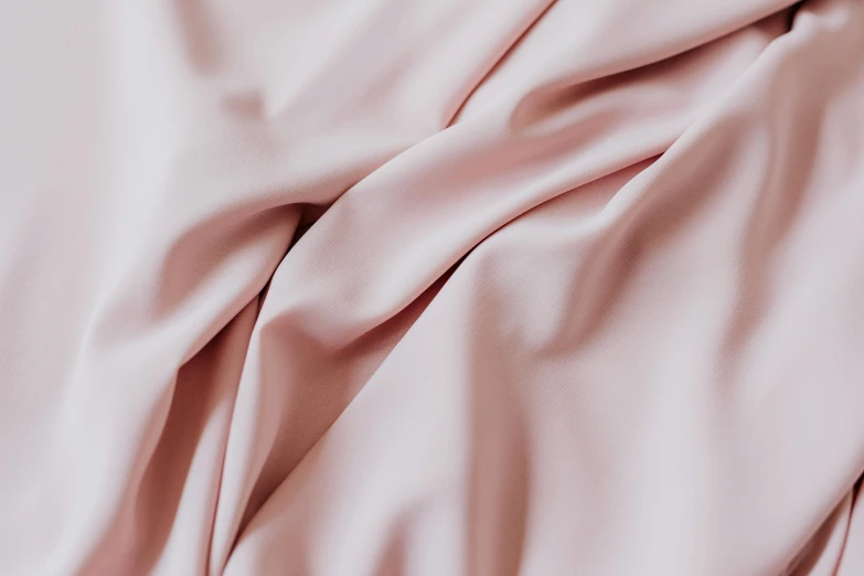 a close up of a pink sheet on a bed, inspired by Anna Füssli, trending on unsplash, smooth porcelain skin, flowing realistic fabric, detailed product image, light tan