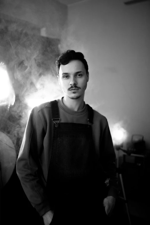 a black and white photo of a man with a moustache, a portrait, reddit, flume, blacksmith, burn, kaethe butcher