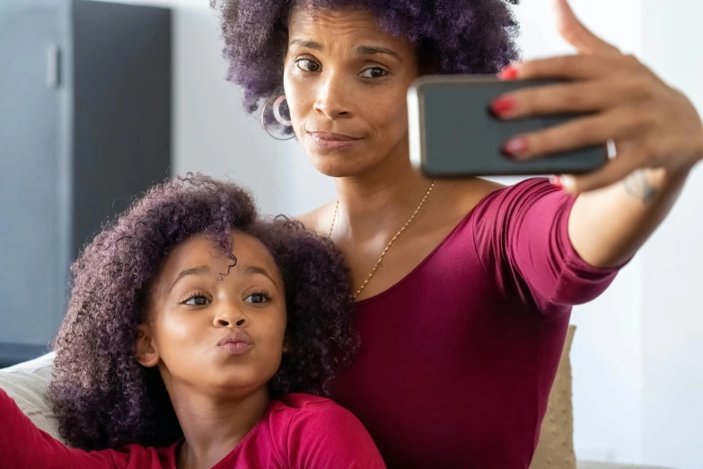 a woman taking a selfie with her daughter, pexels, afrofuturism, purple, ad image, natural hair, digital image