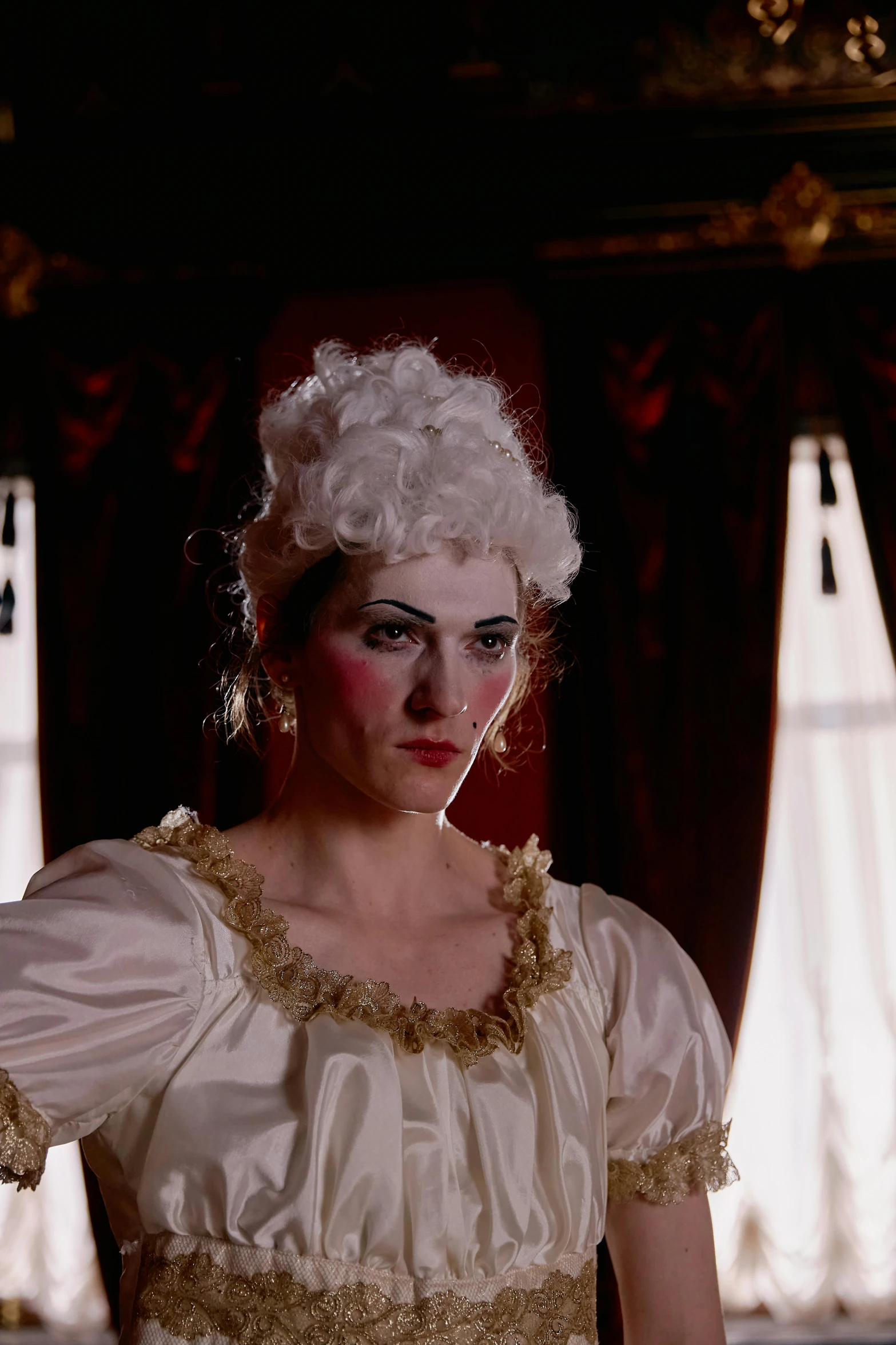 a woman in a white dress standing in a room, inspired by Thomas Lawrence, rococo, face of mad pulcinella, vhs screencap, traditional makeup, [ theatrical ]