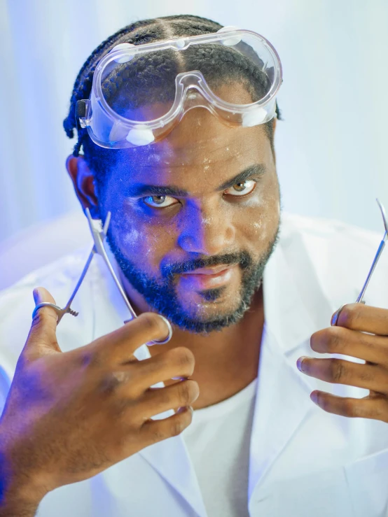 a man in a lab coat and goggles holding scissors, inspired by Ismail Gulgee, trending on reddit, glamour shot, silver nitrate photography, avatar image, ice cube