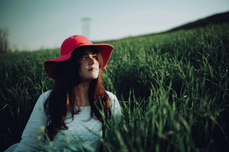 a woman in a red hat sitting in a field, pexels contest winner, avatar image, portrait of a japanese teen, #green, medium format color photography