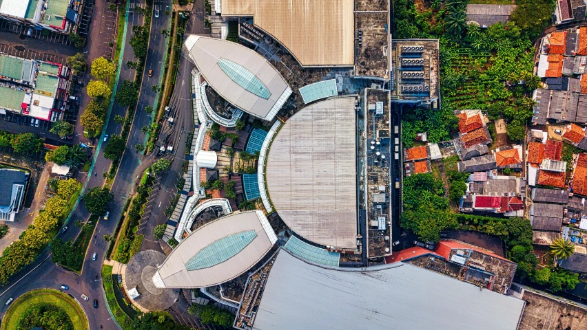 an aerial view of a city with lots of buildings, by Daniel Lieske, pexels contest winner, happening, sportspalast amphitheatre, indonesia, building cover with plant, panels