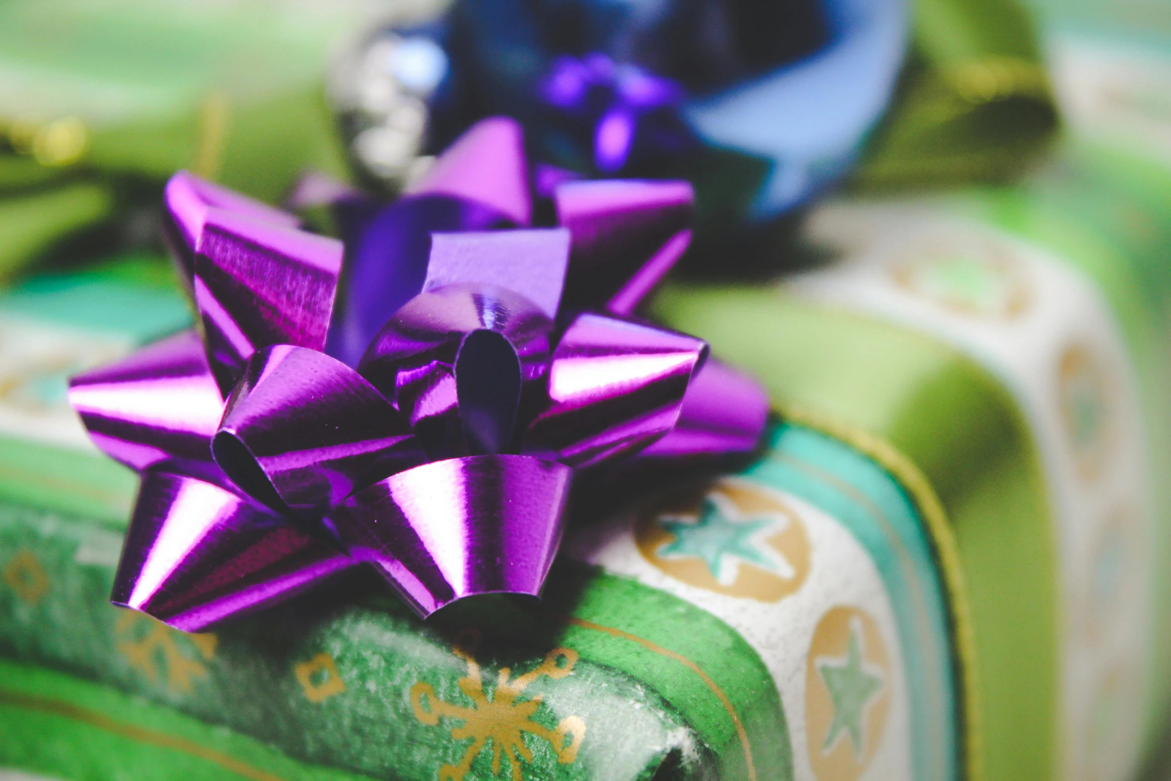 a pile of wrapped presents with purple and green bows, pexels, middle close up, green, thumbnail, handsome