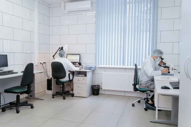 a couple of people sitting at desks in a room, clean medical environment, yaroslav tokar, profile image, uhq