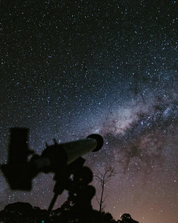 a man looking through a telescope at the night sky, trending on unsplash, milky way nebula, grainy, instagram story, southern cross