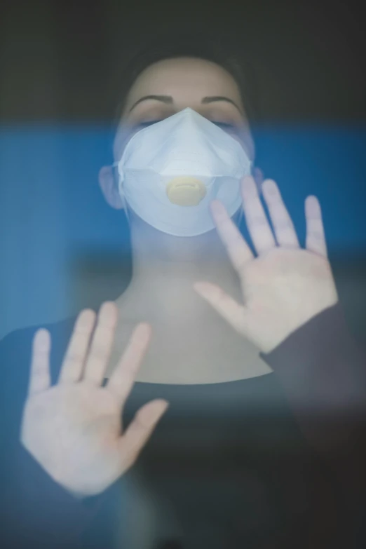 a close up of a person wearing a face mask, a picture, by Paul Davis, shutterstock, happening, floating translucent graphics, square, hands, medical image