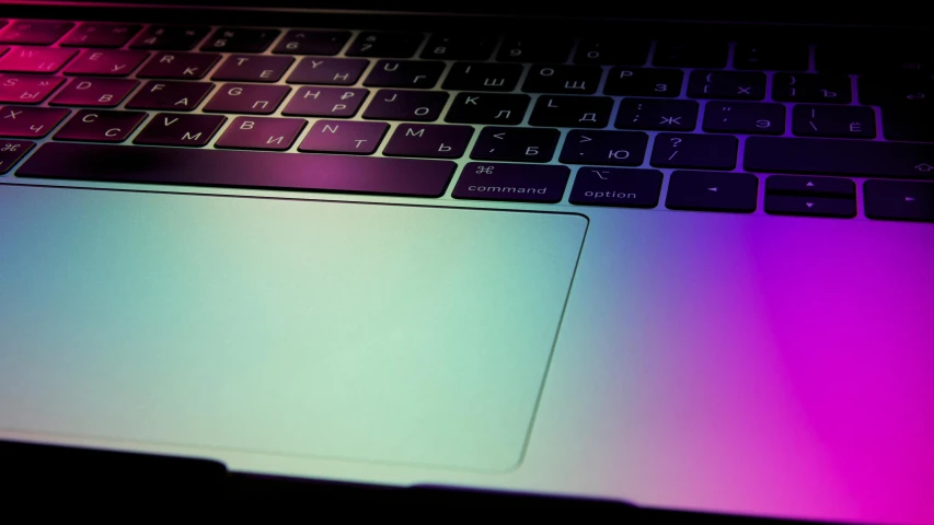 a laptop computer sitting on top of a table, by Carey Morris, pexels, computer art, rim lights purple and green, skin reflective metallic, gradient light blue, apple
