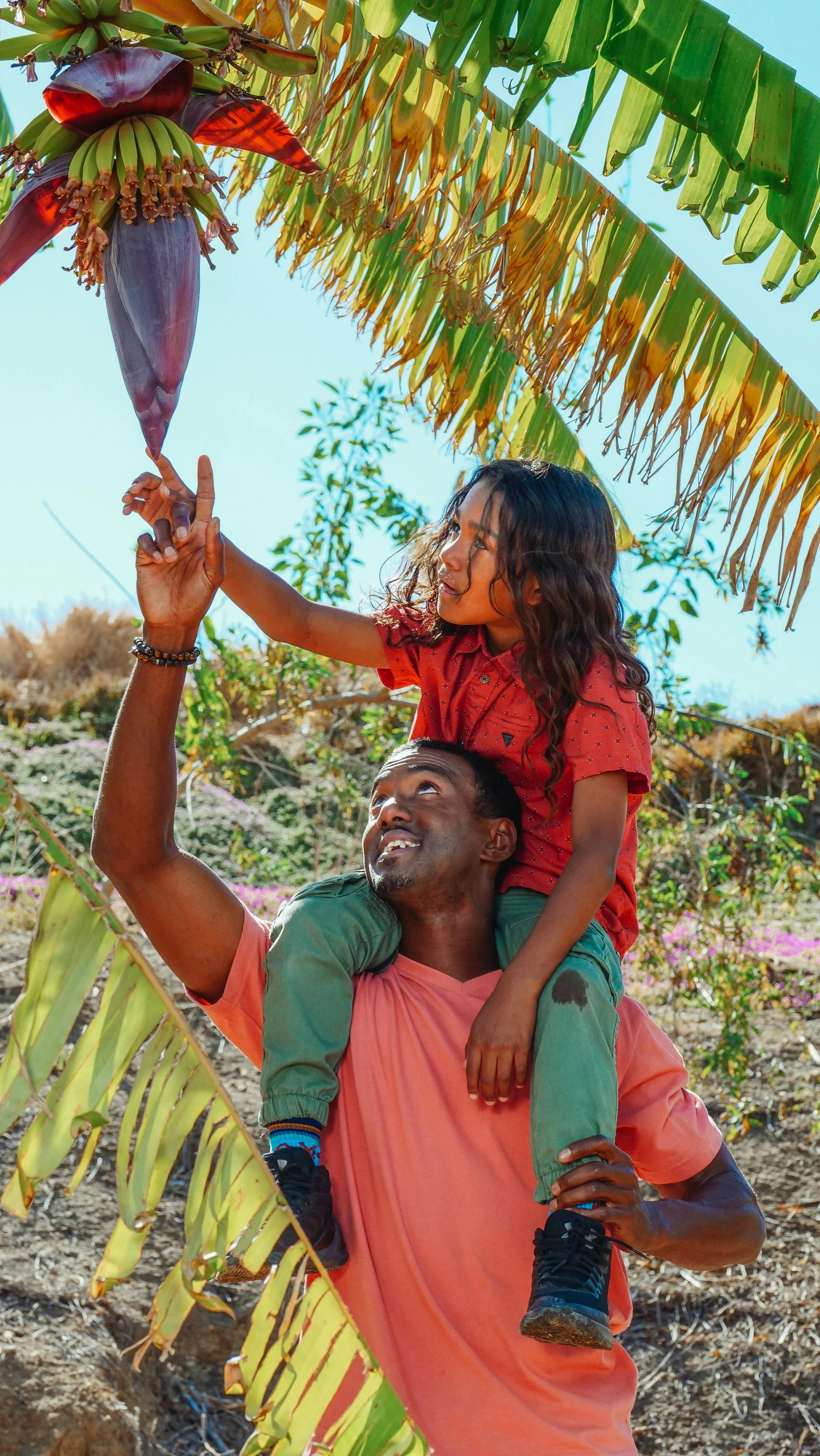 a man holding a little girl on his shoulders, by Jessie Algie, pexels contest winner, figuration libre, holding spear, png, environmental shot, bright vivid colors