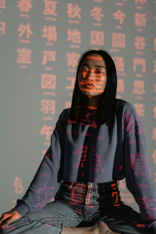 a woman sitting in the middle of a yoga pose, an album cover, inspired by Zhang Xiaogang, trending on pexels, holography, she is wearing streetwear, standing in a dimly lit room, kanji, 15081959 21121991 01012000 4k