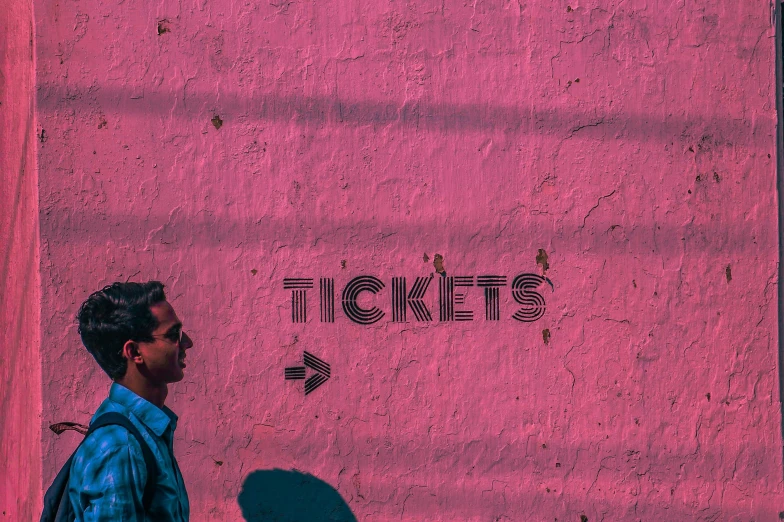 a man standing in front of a pink wall, an album cover, pexels contest winner, graffiti, faked service ticket, chairlifts, website banner, ticket