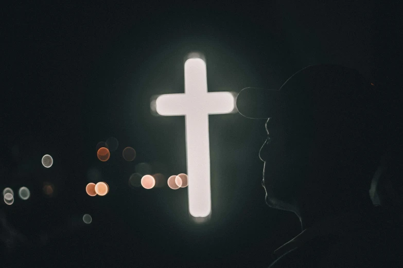 a person standing in front of a cross at night, profile image, instagram post, backlighted, fluorescent