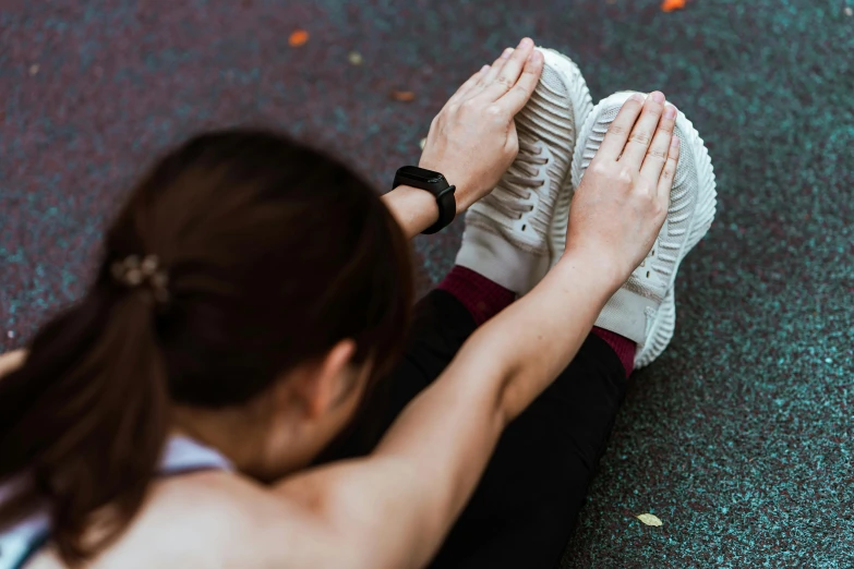 a woman sitting on the ground tying up her sneakers, pexels contest winner, pixeled stretching, avatar image, running pose, half body photo