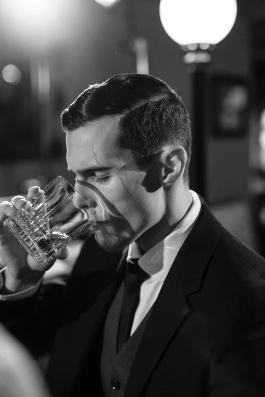 a man in a suit drinking from a glass, an album cover, inspired by George Hurrell, flickr, purism, brass horns, henry cavill!!!, trumpet, monochrome