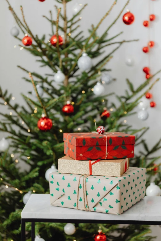 presents stacked on top of each other in front of a christmas tree, profile image, multiple stories, large)}], product shot