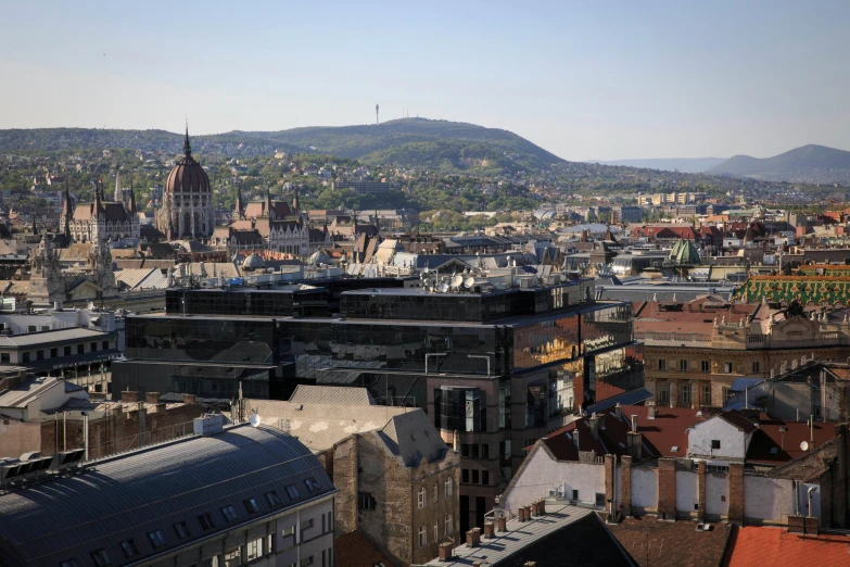 a view of a city from the top of a building, inspired by Jenő Gyárfás, pexels contest winner, hills in the background, square, herzog de meuron, brown