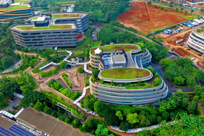 an aerial view of a building with a green roof, inspired by Tadao Ando, renaissance, singapore, thumbnail, wideshot, medical complex