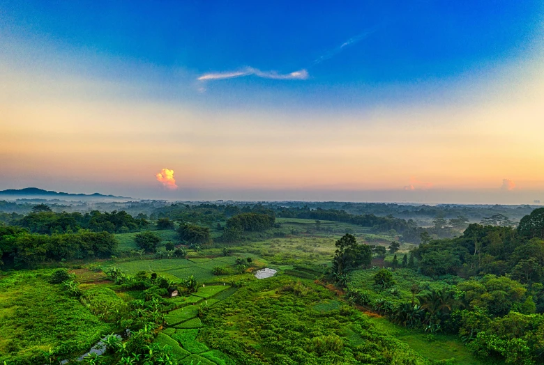 the sun is setting over a lush green valley, a matte painting, pexels contest winner, sumatraism, sri lankan landscape, ultrawide lens”, overlooking, conde nast traveler photo