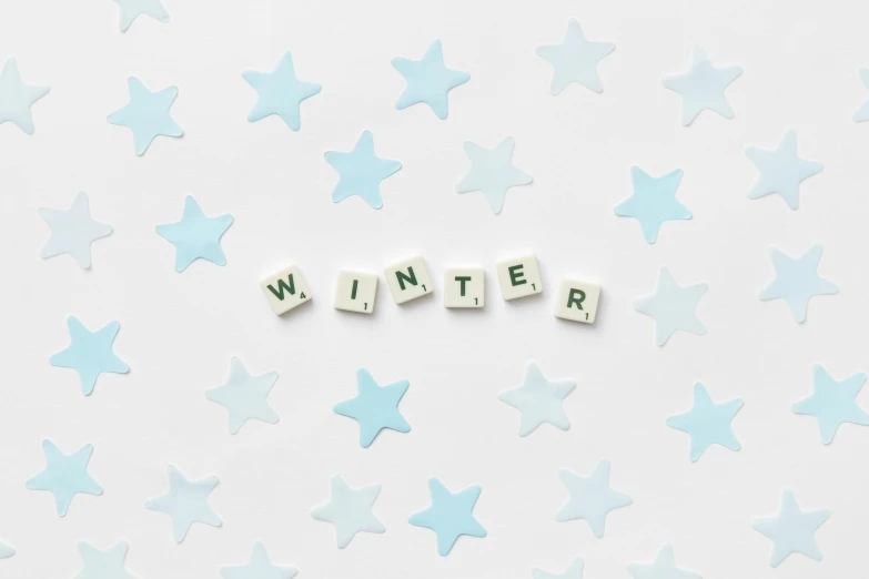 the word winter spelled in scrabbles on a white background, an album cover, by Emma Andijewska, pexels contest winner, stars, background image, pattern, pastel