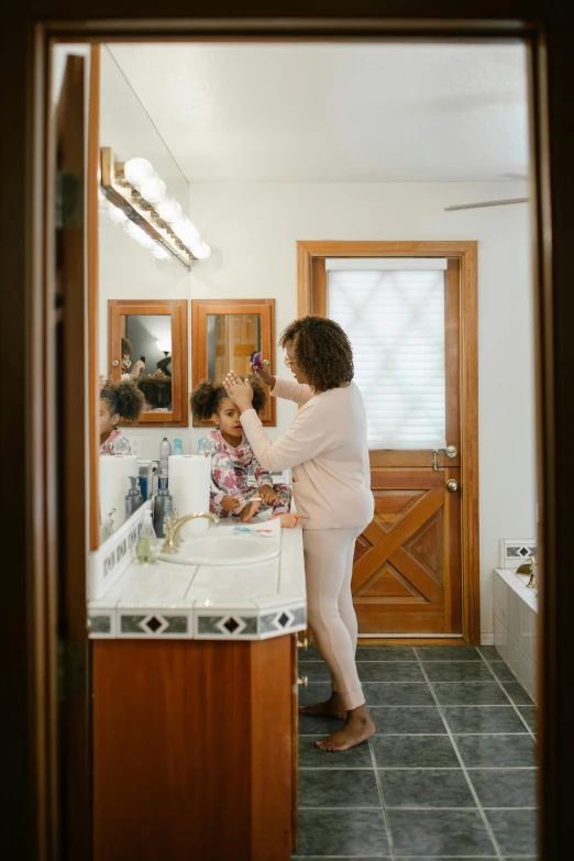 a woman brushing a child's hair in a bathroom, dwell, beautiful surroundings, uploaded, standing