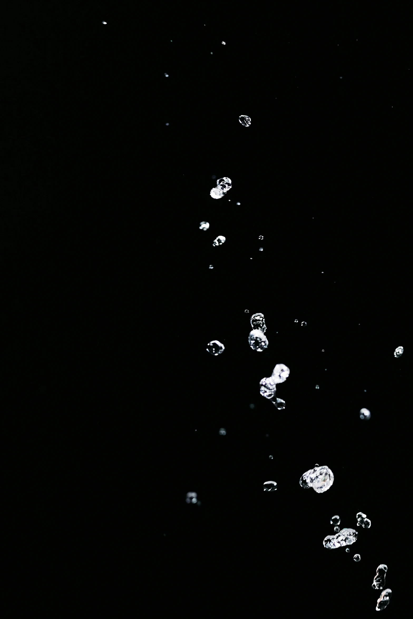 a bottle of water with bubbles coming out of it, a microscopic photo, inspired by Lucio Fontana, unsplash, black space, [ floating ]!!, low quality footage, swarovski crystals
