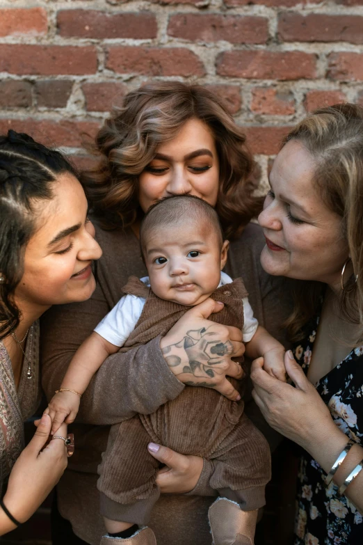 a group of women standing next to each other holding a baby, a photo, trending on unsplash, non binary model, latinas, high angle close up shot, multiple stories