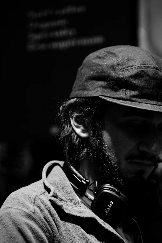 a black and white photo of a man wearing headphones, a black and white photo, unsplash, process art, berets, adam driver, taken in the late 2010s, portrait of bedouin d&d