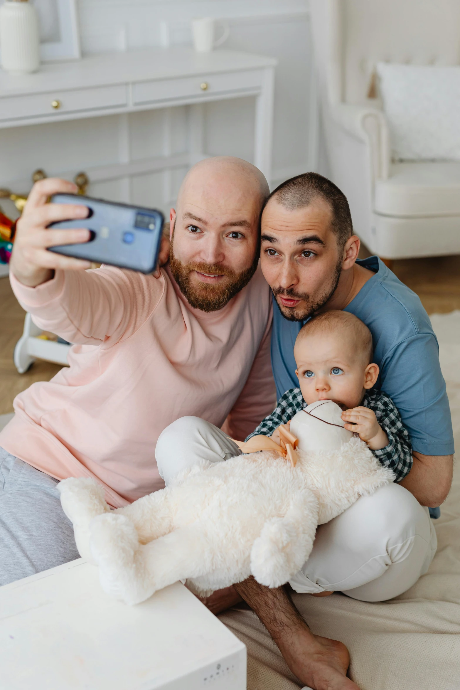 a man and woman taking a selfie with a baby, a polaroid photo, by Julia Pishtar, pexels contest winner, bald with short beard, lgbt, two men hugging, toys