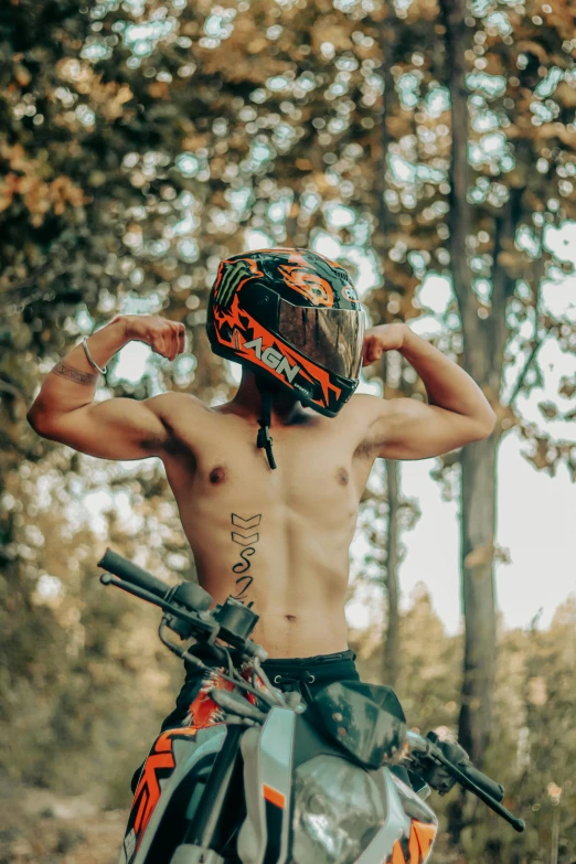 a man standing on top of a dirt bike, inspired by Cam Sykes, trending on pexels, showing off biceps, wearing an elaborate helmet, forest punk, avatar image