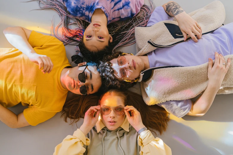 a group of people laying on top of each other, a portrait, trending on pexels, renaissance, wearing round glasses, bella poarch, neon jungle, suns