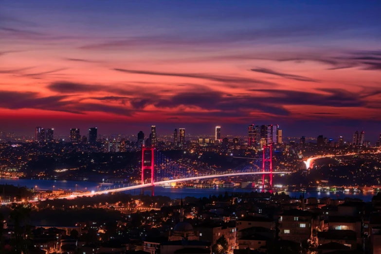 a view of a city at night from the top of a hill, by Yasar Vurdem, pexels contest winner, hurufiyya, red sky blue, elegant bridges between towers, pink marble building, istanbul