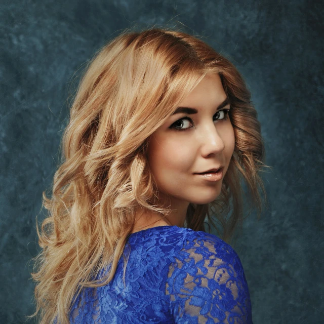 a woman in a blue dress posing for a picture, light gold hair, sofya emelenko, vocalist, trending on imagestation