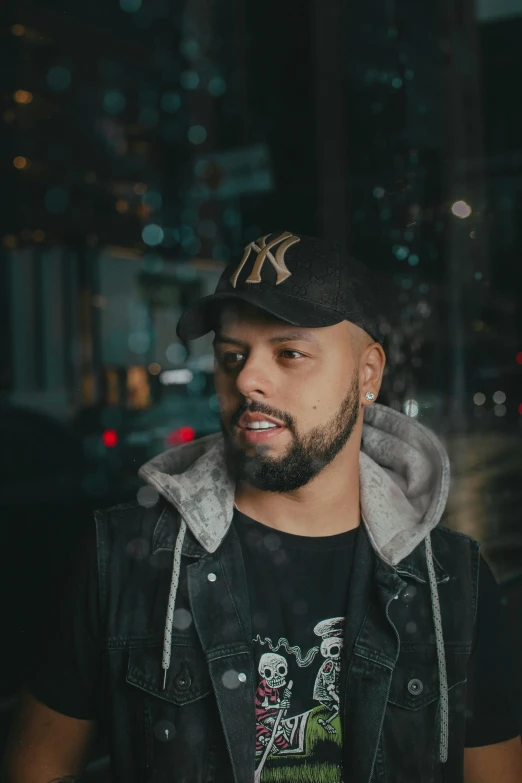 a man standing in front of a window at night, an album cover, by Július Jakoby, headshot profile picture, rapper, fritz willis, dark backdrop