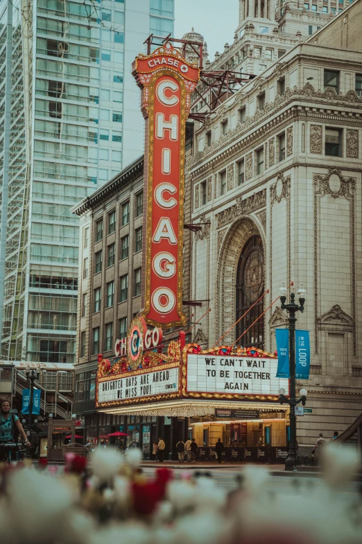 a theater marquee in the middle of a city, by Chris Rahn, pexels contest winner, chicago, square, low quality photo, brown