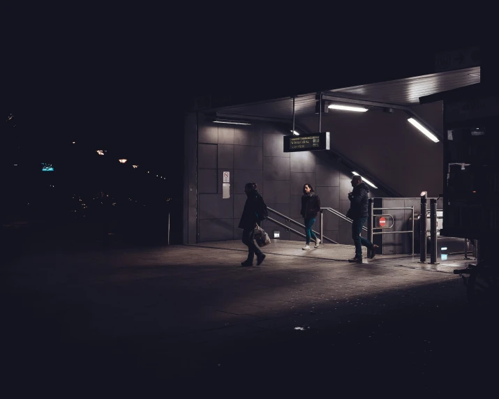 a person walking out of a building at night, by Thomas Häfner, pexels contest winner, happening, bus stop, terminal, dark people discussing, slightly minimal