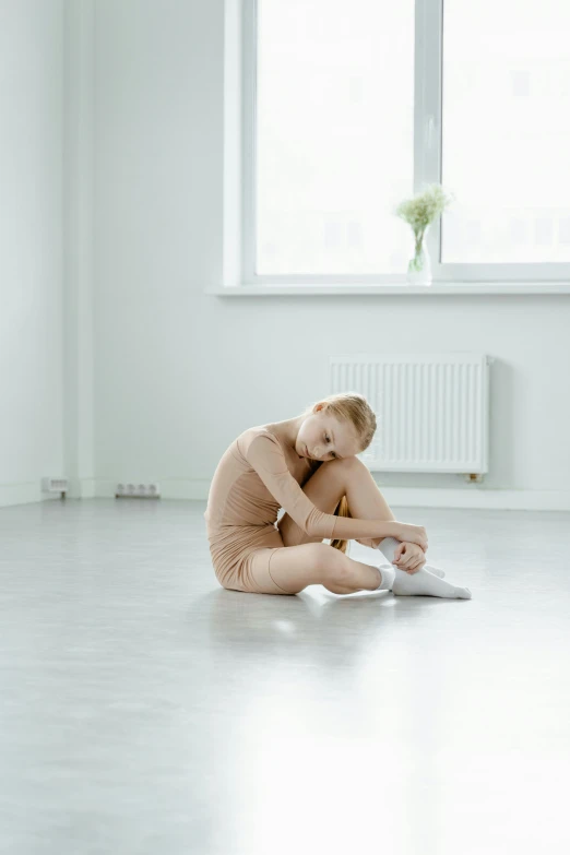 a little girl that is sitting on the floor, by Elizabeth Polunin, sitting in an empty white room, meditative sacral pose, kirsi salonen, promo image