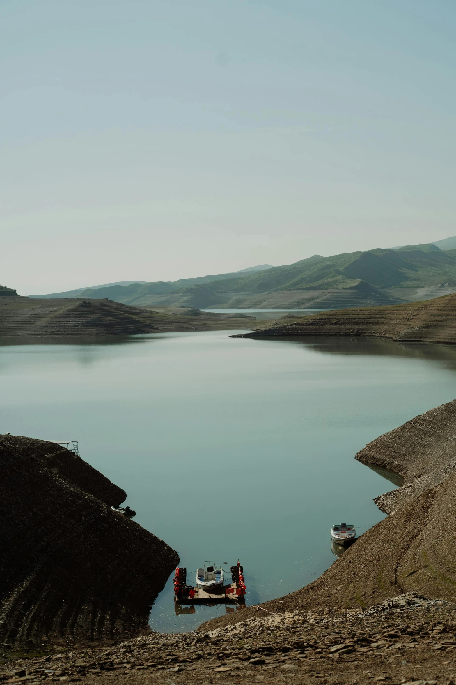 a couple of boats sitting on top of a lake, by Muggur, iran, slide show, graphic print, brown