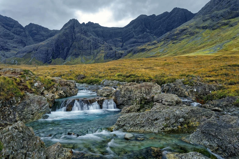 a river running through a lush green valley, an album cover, pexels contest winner, hurufiyya, scottish, icy mountains in the background, avatar image, wet grass and stones